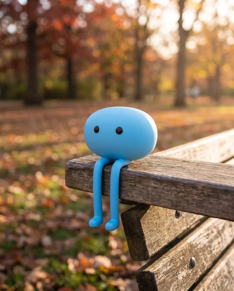 Chipo sitting on a park bench in autumn