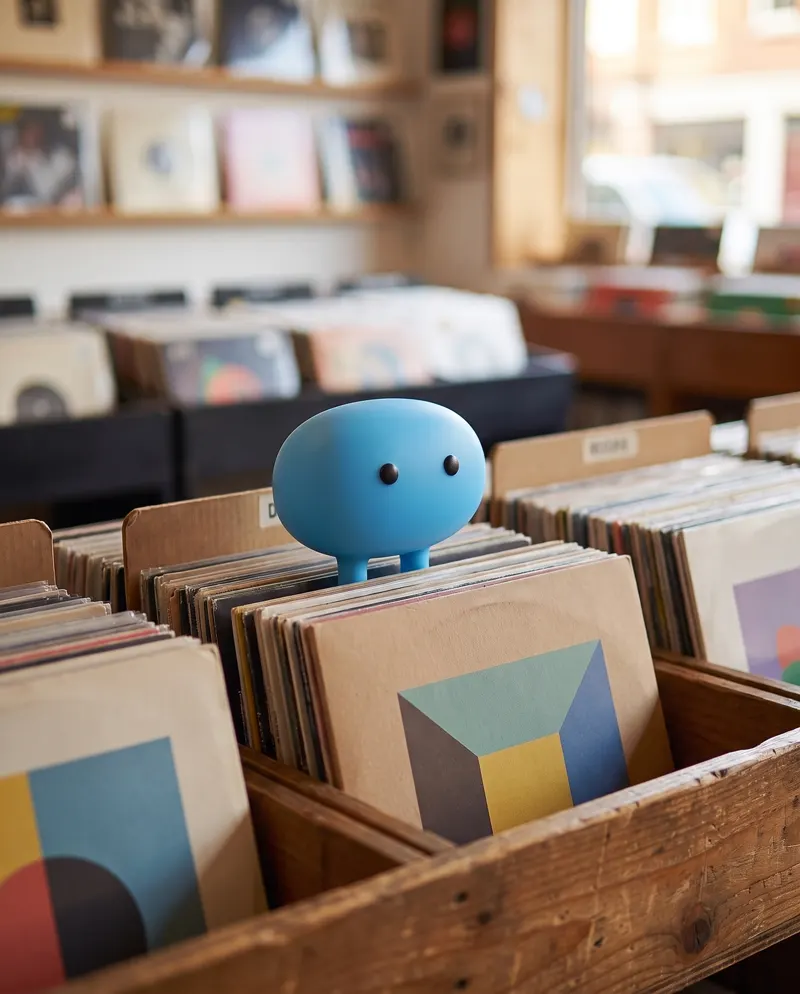 Chipo standing on a crate of vinyl records